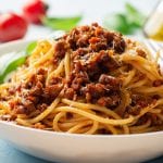 Spaghetti pasta bolognese in plate on concrete background