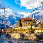 MERANO,ITALY - January 6, 2022. Merano o Meran is a city and comune in South Tyrol, northern Italy. Generally best known for its spa resorts. Passer River, Alps mountains in winter time.