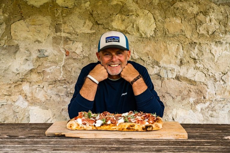 Denis Lovatel e la pizza alla pala|Raccolta di fiori eduli in montagna|Denis Lovatel con una mucca di Malga Domador|preparazione della pizza alla pala su stufa a legna|Malga Domador