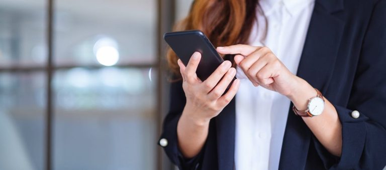 Una ragazza intenta a usare lo smartphone