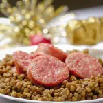 Italian cotechino with lentils on christmas table.