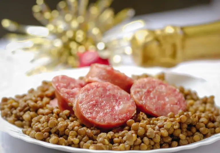 Italian cotechino with lentils on christmas table.